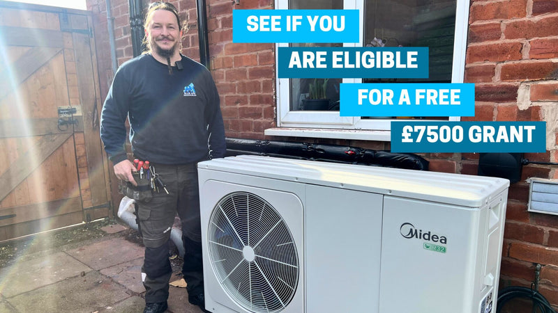 Installers fitting an air source heat pump at a UK home